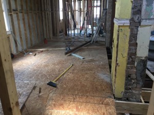 The new sub floor in the master suite. Notice the fireplace. They still have to knock the stucco off of it. 